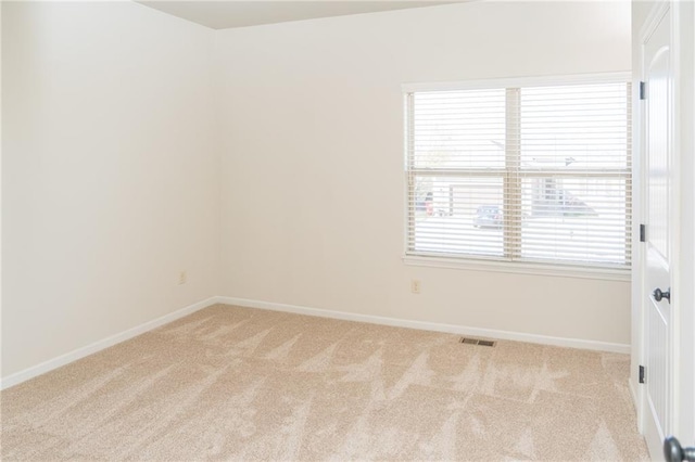2200 NW Hedgewood Dr, Grain Valley, MO 64029 - spare room featuring light carpet and baseboards