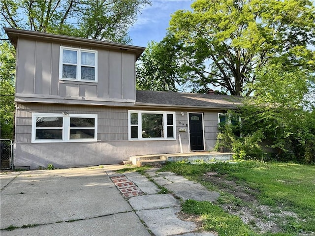 traditional home with board and batten siding and a patio area