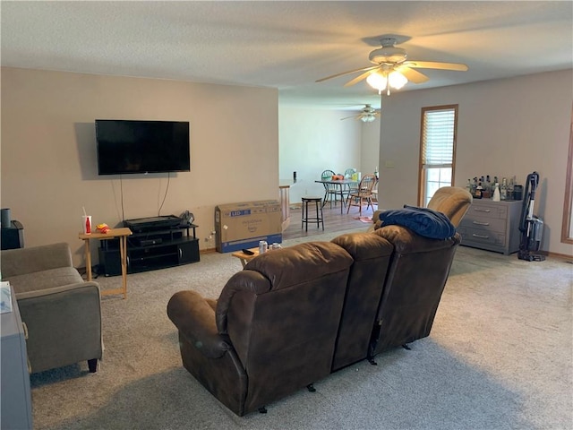 living room with light colored carpet and a ceiling fan