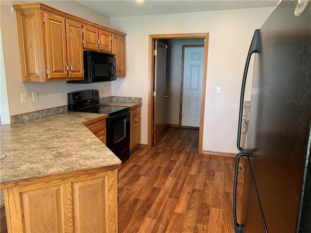 1019 S Hugh St, Frontenac, KS 66763 - kitchen with black appliances, light countertops, wood finished floors, brown cabinets, and a peninsula