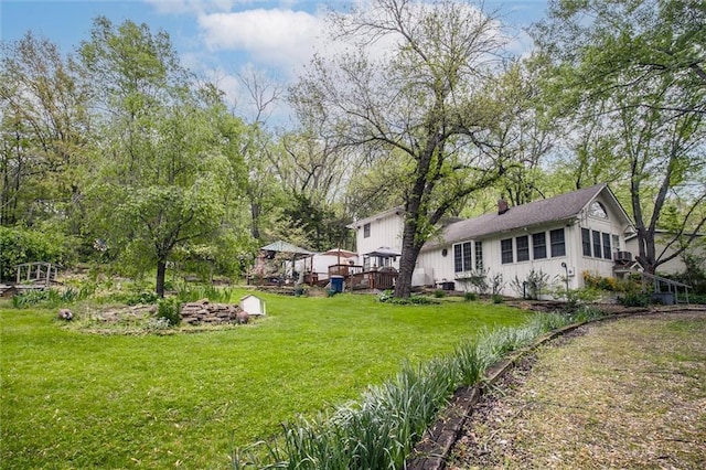 view of yard featuring a deck and a gazebo