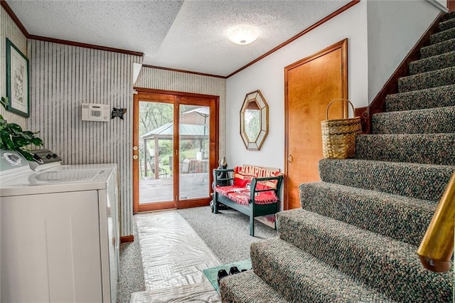 laundry area featuring separate washer and dryer, ornamental molding, carpet flooring, and a textured ceiling
