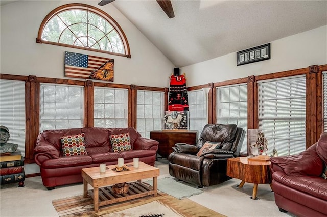 carpeted living room featuring ceiling fan and high vaulted ceiling