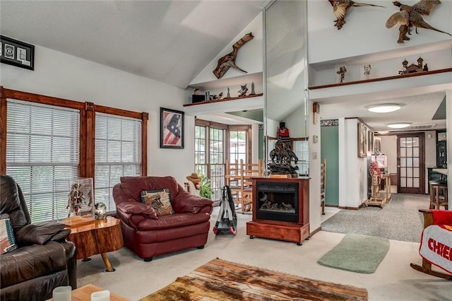 living room featuring carpet floors and high vaulted ceiling