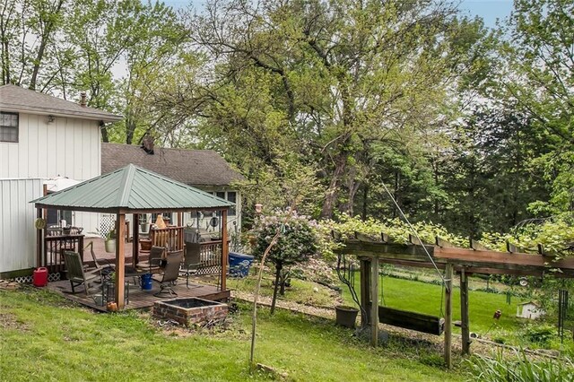 view of yard featuring a wooden deck and a gazebo