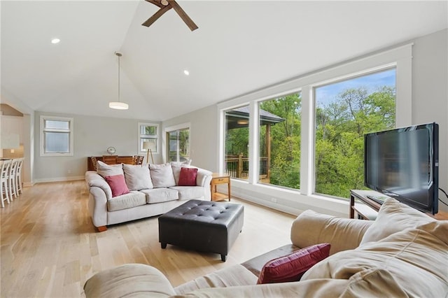 living area featuring a ceiling fan, vaulted ceiling, baseboards, light wood-style floors, and recessed lighting
