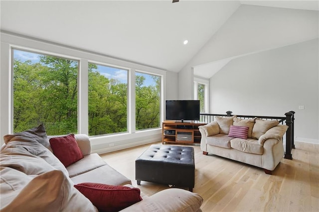 living area with recessed lighting, wood finished floors, and lofted ceiling