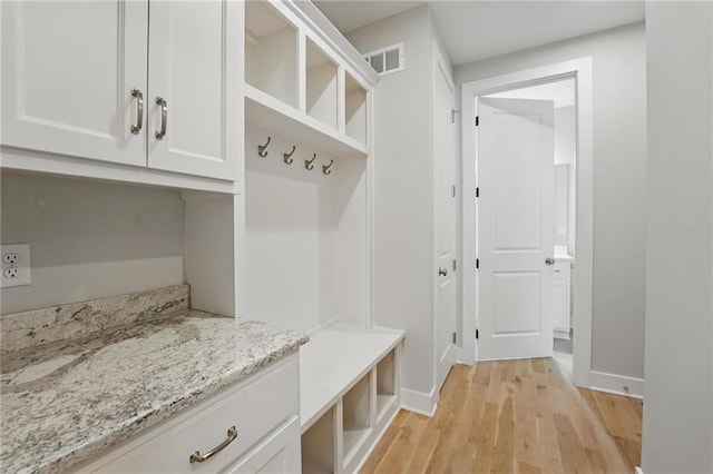 mudroom featuring baseboards, visible vents, and light wood-style flooring
