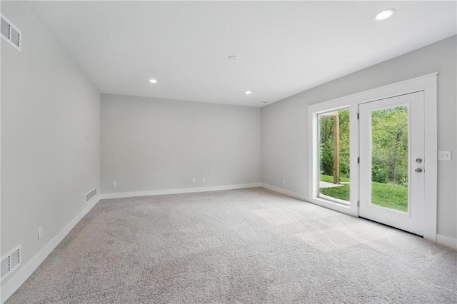 carpeted empty room featuring baseboards, recessed lighting, and visible vents