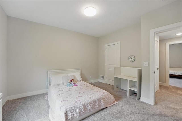 bedroom with baseboards, carpet, and visible vents