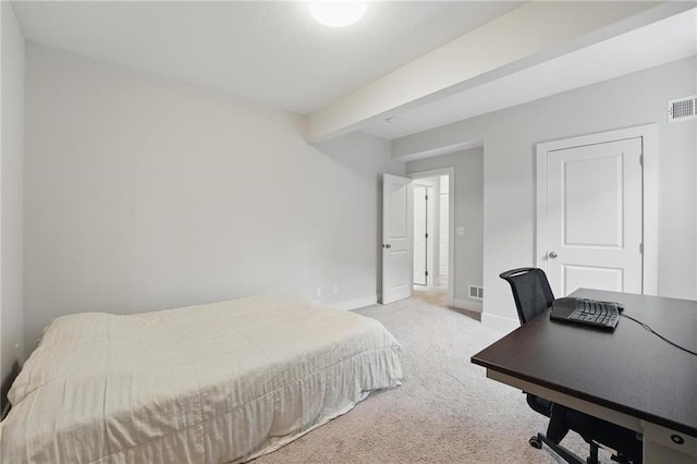 carpeted bedroom with baseboards and visible vents