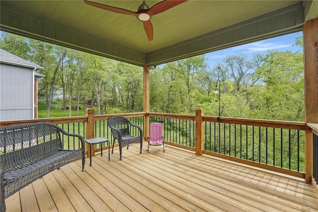 wooden terrace featuring a ceiling fan