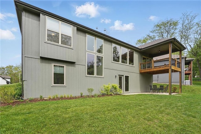 rear view of house featuring central AC unit, a yard, a patio area, and a balcony