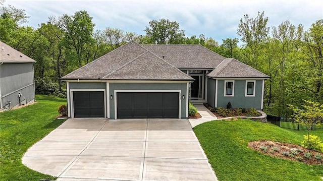 ranch-style home with a shingled roof, a garage, stucco siding, a front yard, and concrete driveway