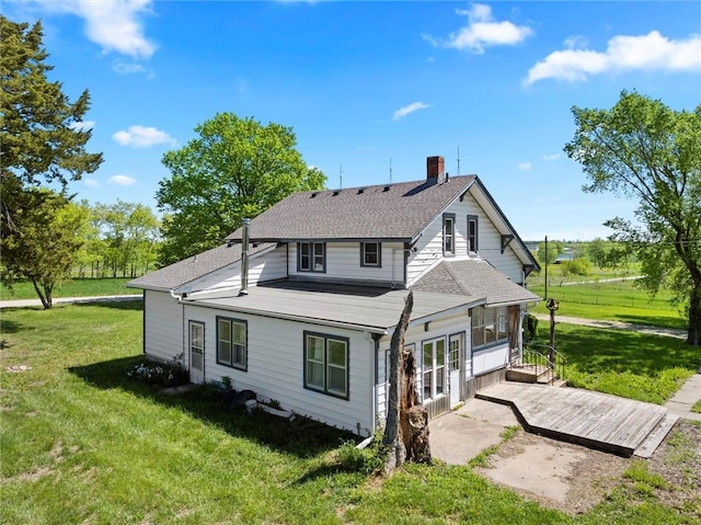 657 N 400th Rd, Overbrook, KS 66524 - back of house featuring a chimney, a lawn, a patio, and a shingled roof
