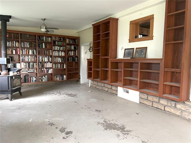 657 N 400th Rd, Overbrook, KS 66524 - misc room featuring concrete floors, wall of books, and a ceiling fan