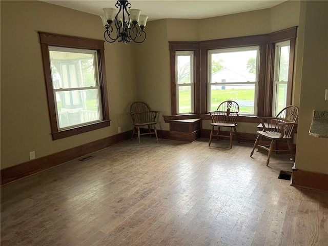 657 N 400th Rd, Overbrook, KS 66524 - living area with a chandelier, wood finished floors, and baseboards