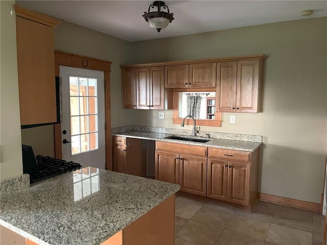 657 N 400th Rd, Overbrook, KS 66524 - kitchen with a sink, a peninsula, baseboards, light stone countertops, and light tile patterned floors