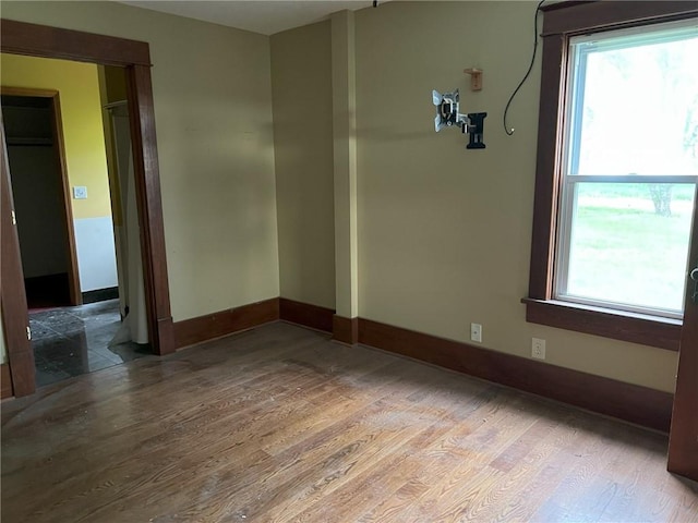 657 N 400th Rd, Overbrook, KS 66524 - empty room featuring wood finished floors, plenty of natural light, and baseboards