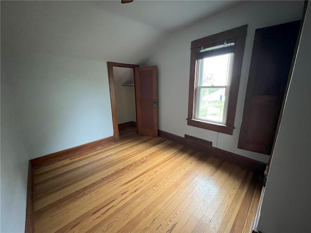 657 N 400th Rd, Overbrook, KS 66524 - unfurnished bedroom with vaulted ceiling, light wood-style floors, baseboards, and a closet