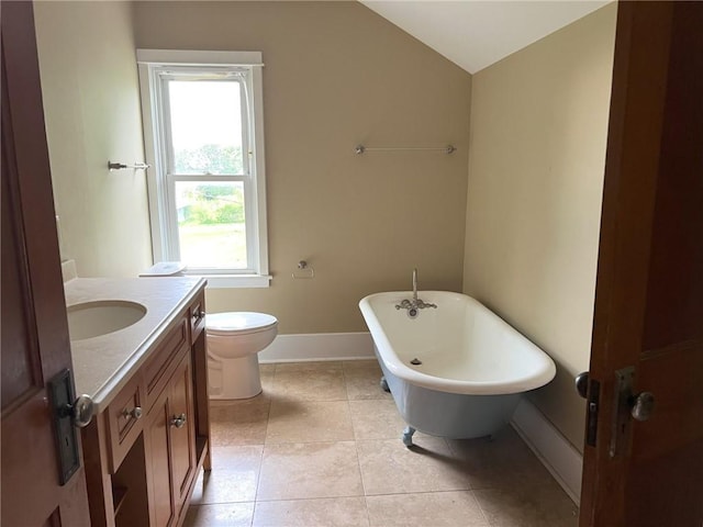 657 N 400th Rd, Overbrook, KS 66524 - full bathroom with lofted ceiling, a freestanding bath, vanity, baseboards, and tile patterned floors