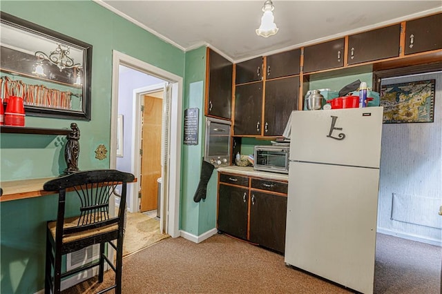 636 S Fuller Ave, Independence, MO 64052 - kitchen with freestanding refrigerator, light colored carpet, ornamental molding, baseboards, and dark brown cabinetry