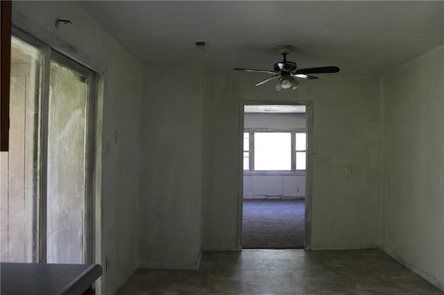 unfurnished room featuring visible vents and ceiling fan