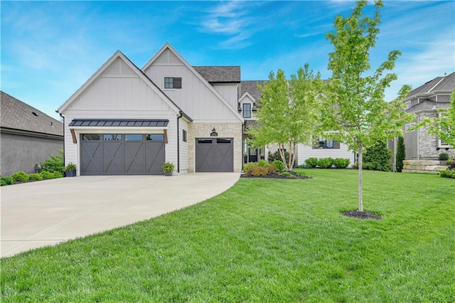 view of front facade with board and batten siding, driveway, a front yard, a garage, and stone siding