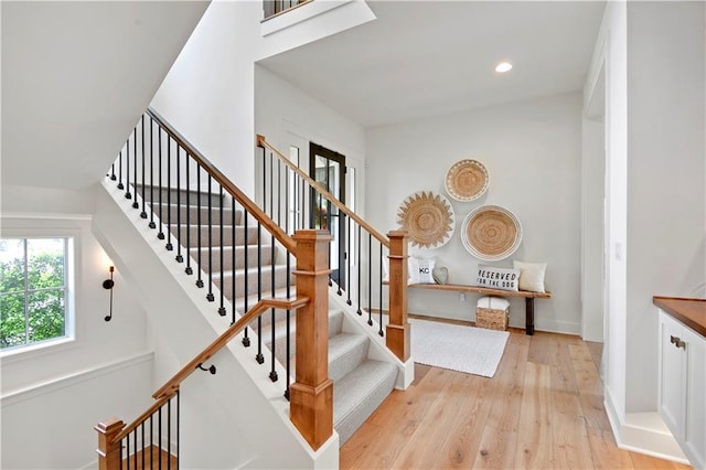 stairway featuring recessed lighting, baseboards, and hardwood / wood-style flooring
