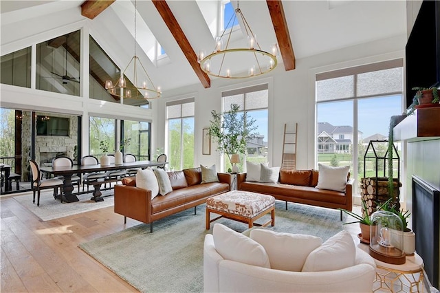 sunroom with an inviting chandelier, a skylight, and beamed ceiling