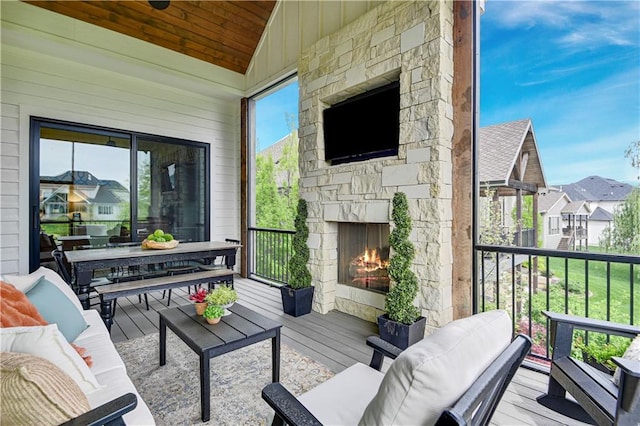 balcony featuring an outdoor living space with a fireplace and a residential view