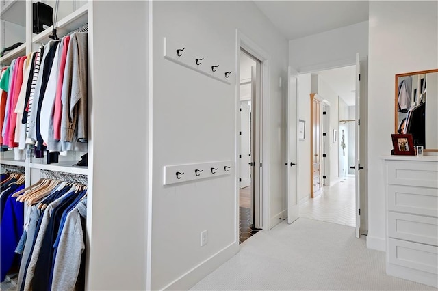 corridor featuring carpet floors and baseboards