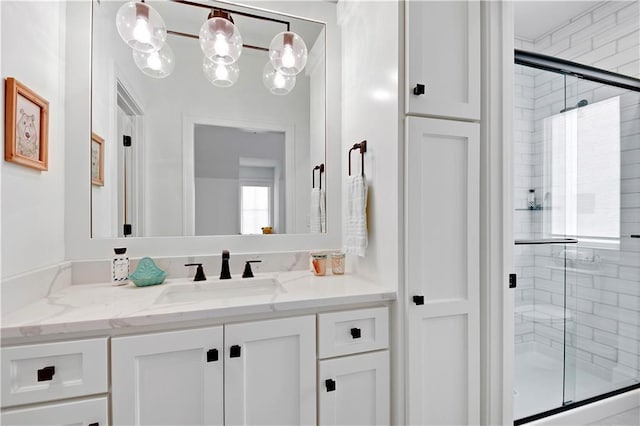full bath with vanity and a shower stall