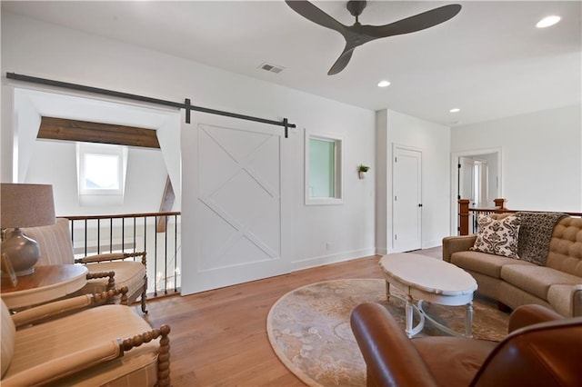living room with visible vents, baseboards, ceiling fan, recessed lighting, and light wood-style flooring