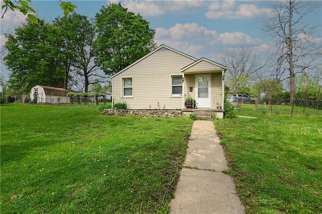 view of front of property with a front lawn and fence