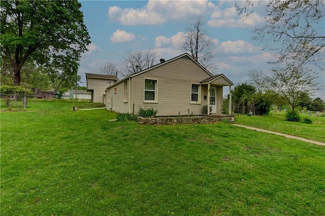 exterior space featuring a yard, fence, and covered porch