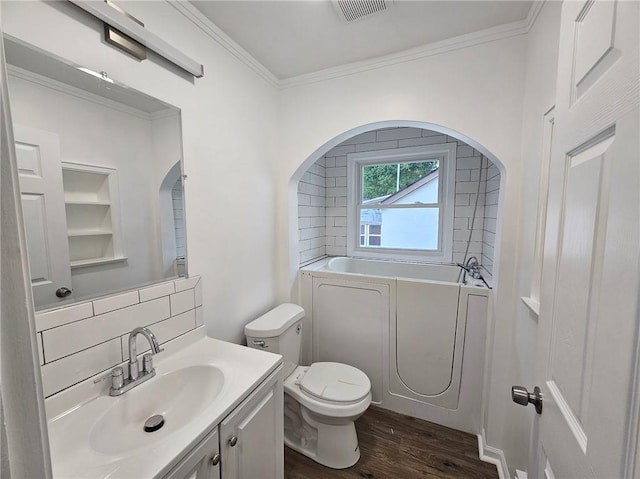 bathroom with toilet, wood finished floors, tasteful backsplash, visible vents, and a bath