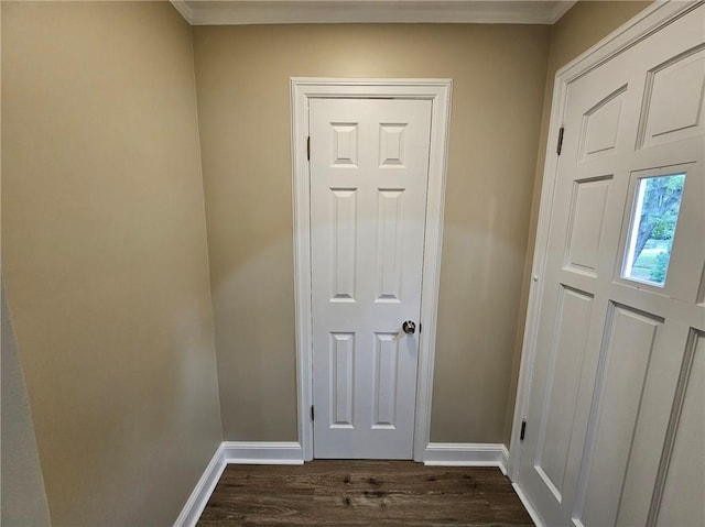doorway to outside with baseboards, ornamental molding, and dark wood-style flooring