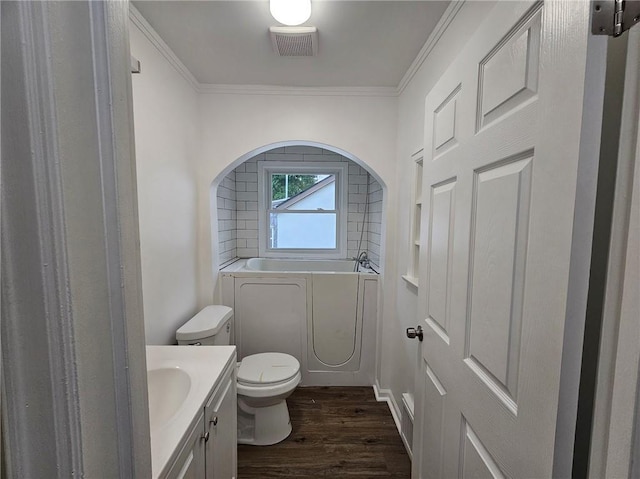 full bathroom with a garden tub, visible vents, wood finished floors, vanity, and toilet