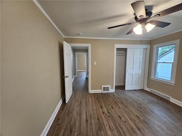 unfurnished bedroom with dark wood-style flooring, baseboards, and visible vents