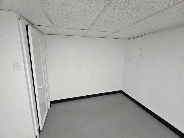 finished below grade area featuring baseboards and a drop ceiling