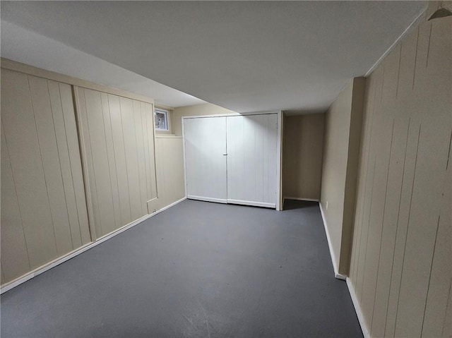 finished basement with wooden walls and baseboards