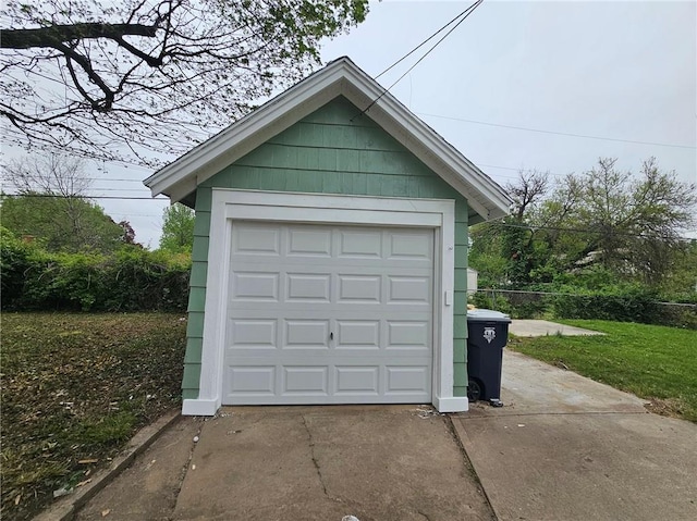 detached garage with concrete driveway
