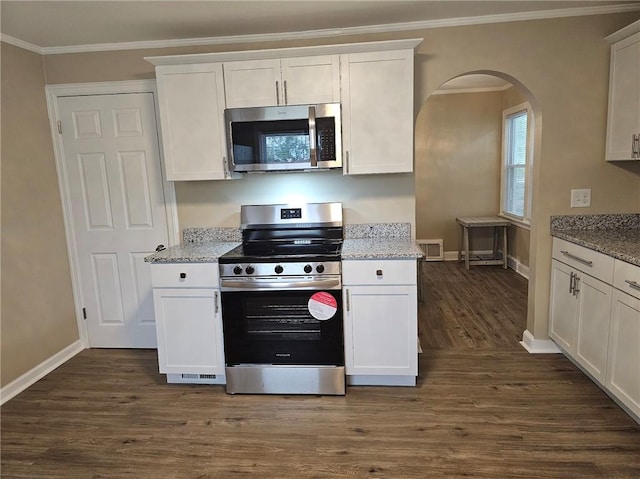 kitchen featuring crown molding, dark wood-style flooring, white cabinets, and stainless steel appliances