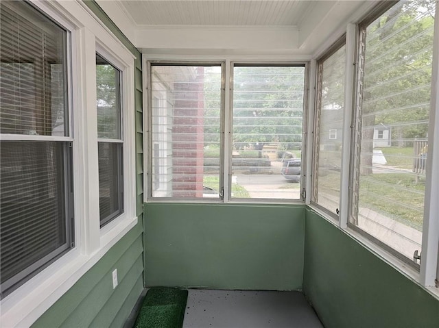unfurnished sunroom with crown molding