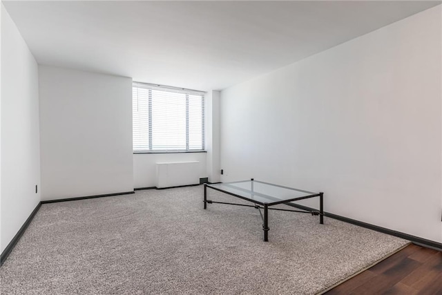 interior space with baseboards and wood finished floors