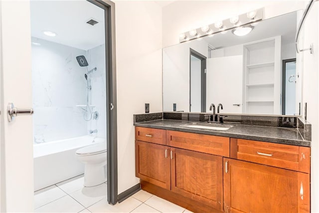 bathroom featuring tile patterned flooring, vanity, toilet, baseboards, and shower / tub combination
