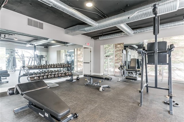 exercise room with visible vents and baseboards