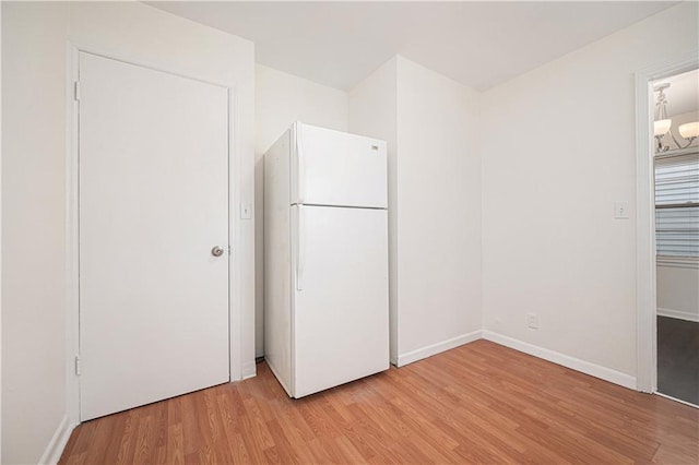 3525-3527 Bell St, Kansas City, MO 64111 - interior space featuring freestanding refrigerator, light wood-style floors, and baseboards