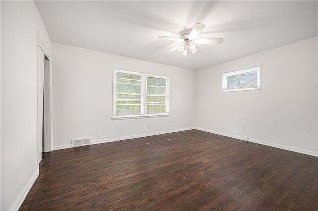 3525-3527 Bell St, Kansas City, MO 64111 - spare room featuring a ceiling fan, baseboards, dark wood-type flooring, and visible vents